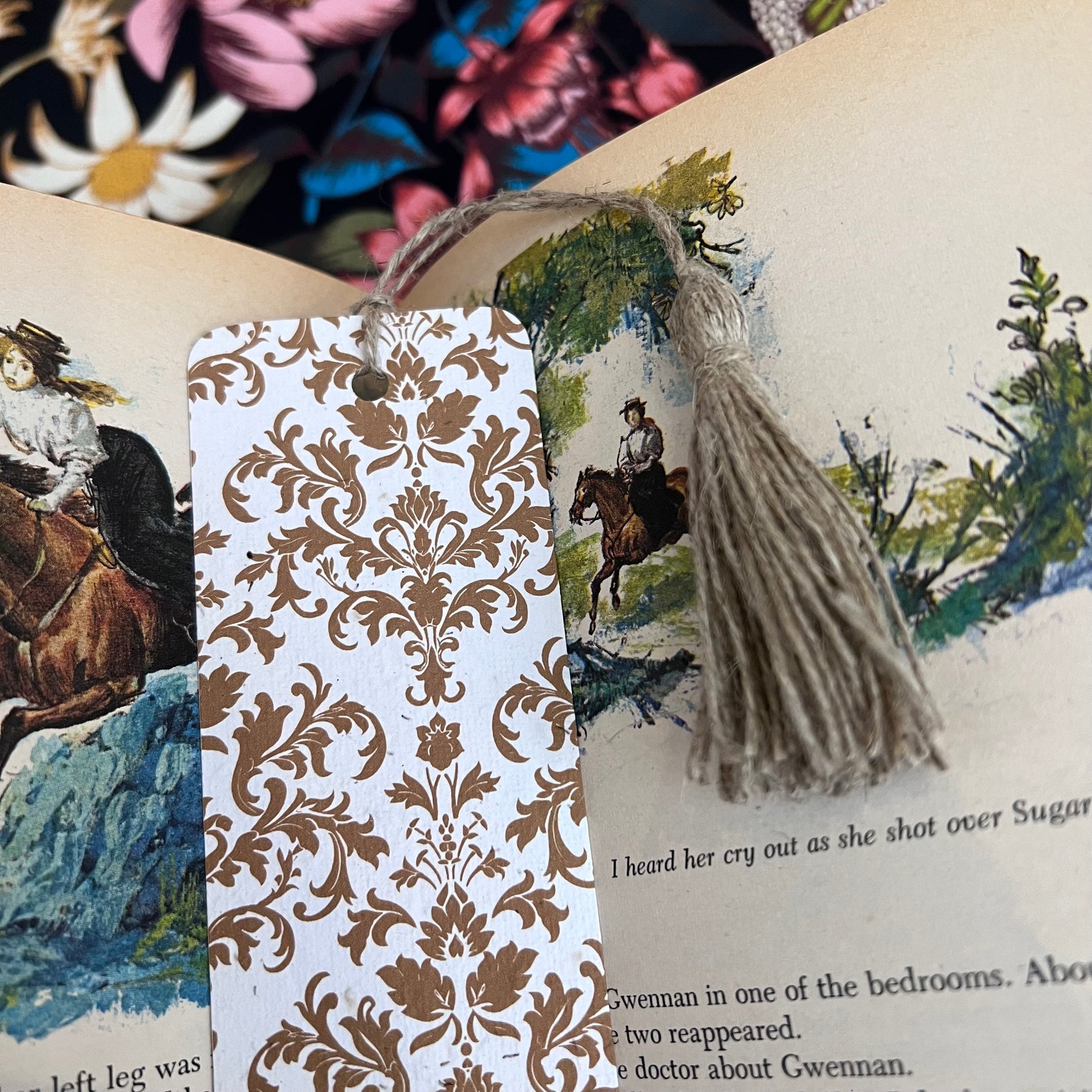 Plantable bookmark with brown damask pattern on an open book page.