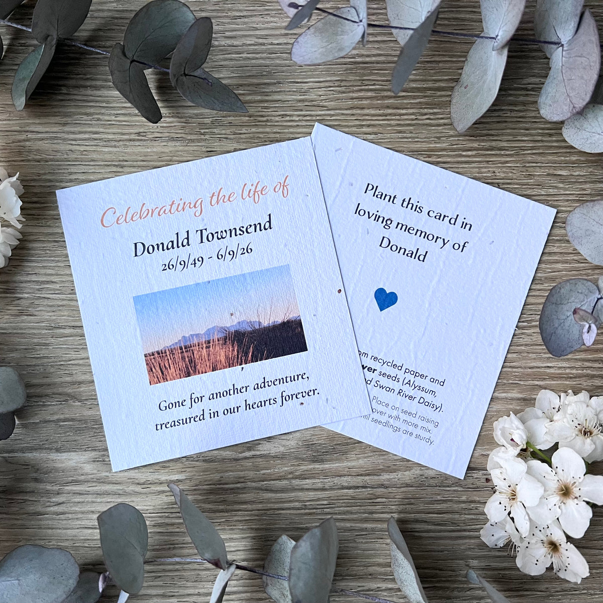 Seed paper memorial cards for ‘Celebrating of life service' with a small landscape photo and memorial quote.